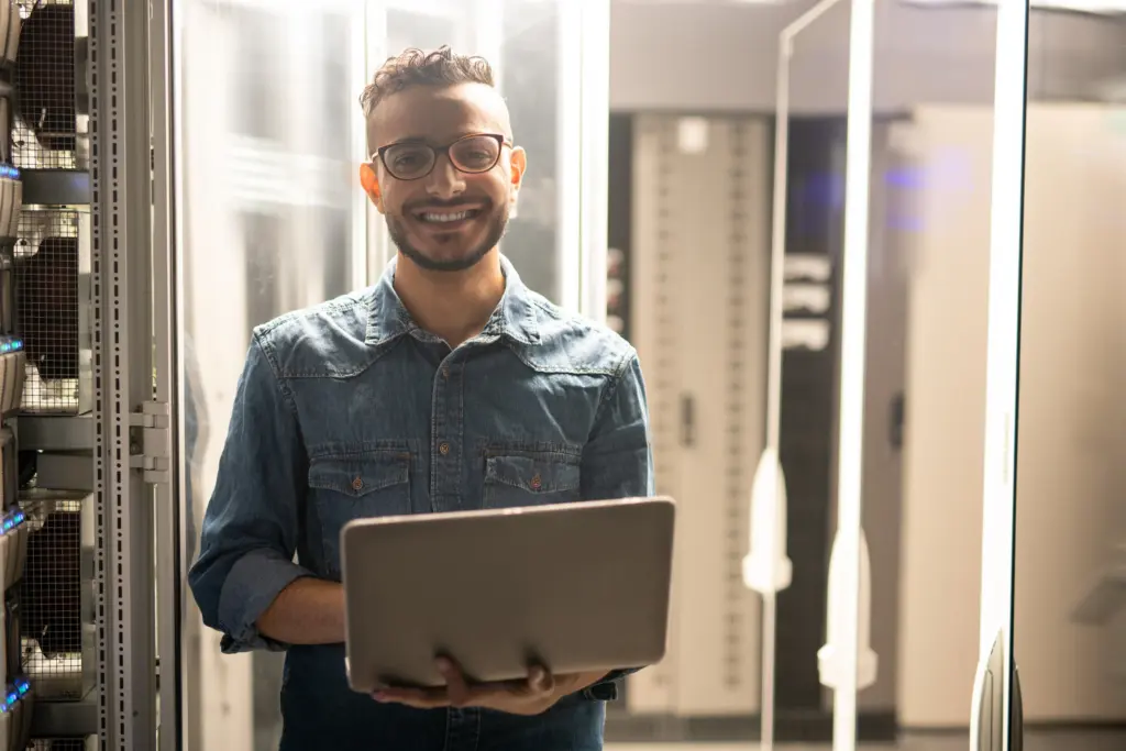 cheerful-server-engineer-in-datacenter-room