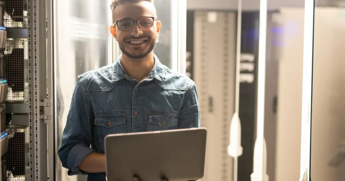cheerful-server-engineer-in-datacenter-room